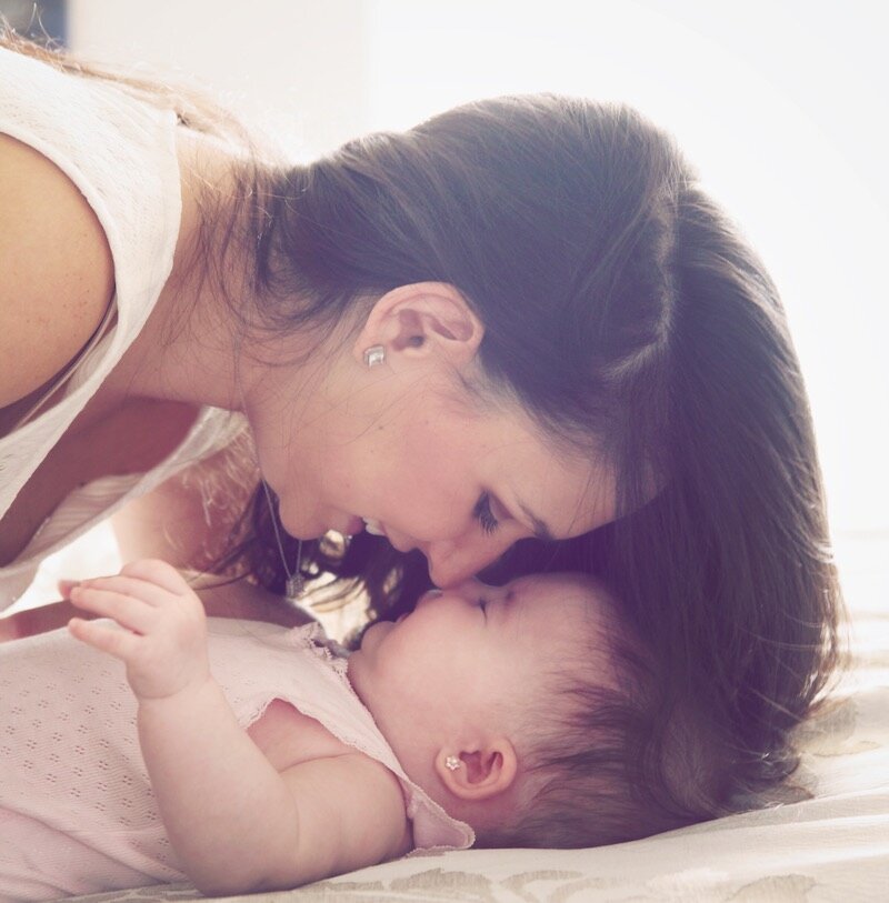 Myriam Sandler playing with her daughter, showcasing the inspiration behind Mothercould's products and community.